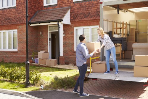 Removal van team loading furniture with safety precautions