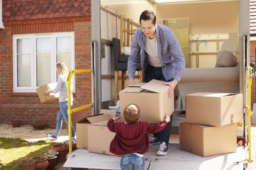 Workers using protective wrapping during a removals job