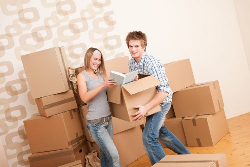 Professional movers packing and protecting household furniture for a Crystal Palace relocation